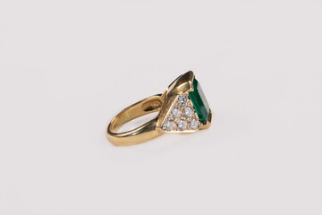 Emerald ring on a white background, sideview