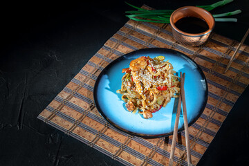 Thai vegetarian vegetables udon noodles in a dark background. Serving Asian dishes in the...