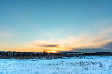 Open field covered in snow and a sunset