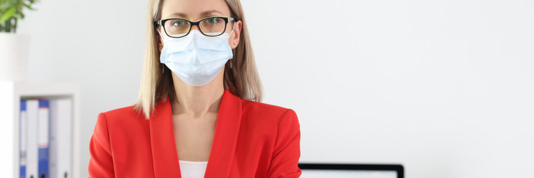 Portrait of businesswoman in medical protective mask and and suit in office. The new reality of covid-19 prevention concept