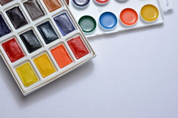 Watercolor paints for painting on a white background.