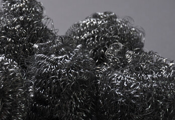 Metal sponges on a gray background.