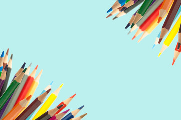 Fototapeta premium colored pencils on a blue background. education concept. illustration of training.