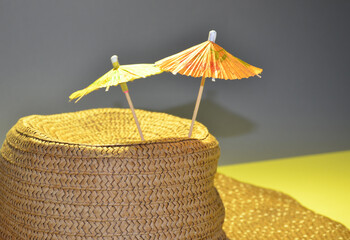 Brown hat and umbrellas on a yellow background. Yellow stars.