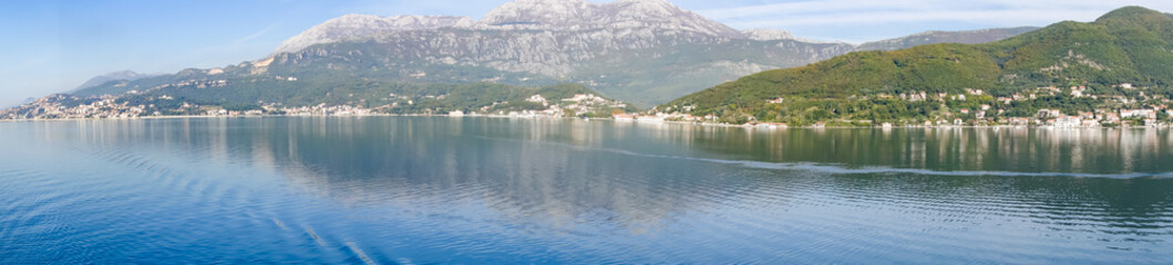 Fototapeta premium Panoramic view of Bay of Kotor from the sea surrounded by mountains in Montenegro, one of the most beautiful bay in the world