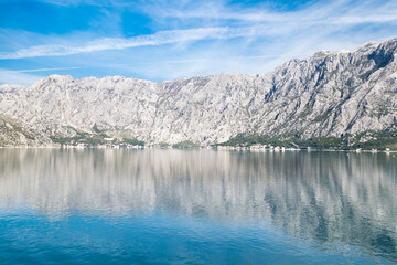 View of Bay of Kotor from the sea surrounded by mountains in Montenegro, one of the most beautiful bay in the world