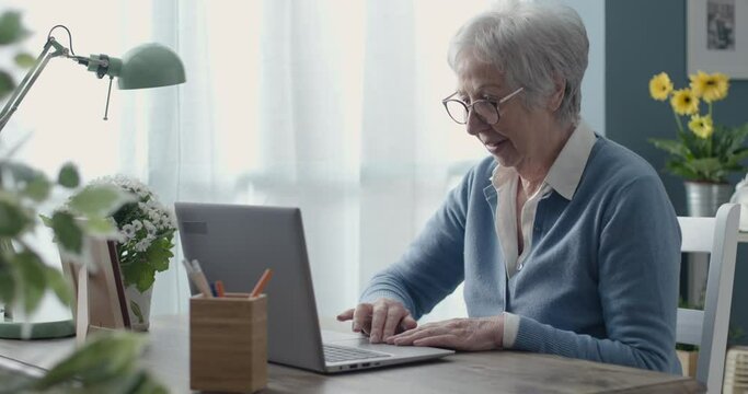 Senior woman using a laptop at home