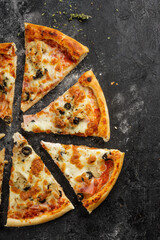 flat lay pizza slices vith tasty ingredients like mushroom, cheese and olives.