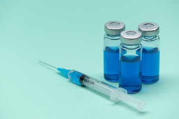 Corona Virus vaccine vials medicine bottles and syringe injection. SARS-CoV-2 Vaccination and immunization, treatment to cure Covid 19 Corona Virus infection. Medical concept.