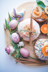Obraz na płótnie Canvas Easter Eggs and Cakes on a Wooden Board 