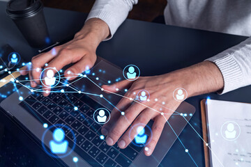 Hands of hr specialist is typing the keyboard in the internet to find the best candidates to create international network in recruitment process. Concept of success. Social media hologram icons.