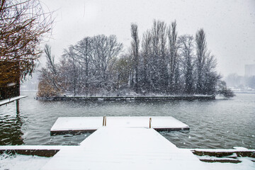 Snow time winter landscape at Herastrau park, Bucharest. Snow is falling, cold day. Beautiful day