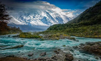 big river with snow mountain in the background in Patagonia, Chile - 414194529