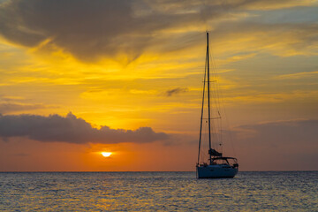 Caribbean, Grenada, Mayreau Island. Sailboat at anchor at sunset.