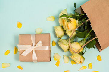 International Women's Day. 8 March, Mother's Day. Greeting Card. Decoration with gift box and yellow bouquet roses on a light background