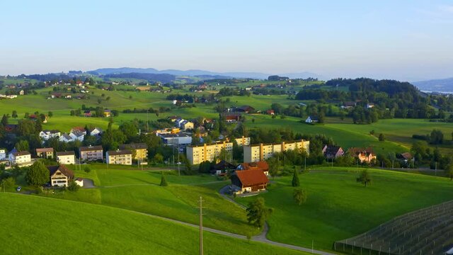 Drone rotating shot of a village, Samstagern in Richterswil, Zurich, Switzerland in a summer morning