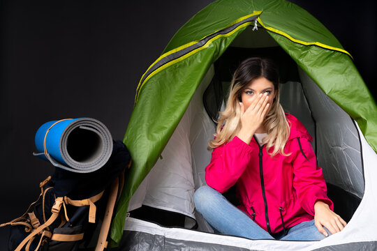 Teenager Girl Inside A Camping Green Tent Isolated On Black Background Nervous And Scared