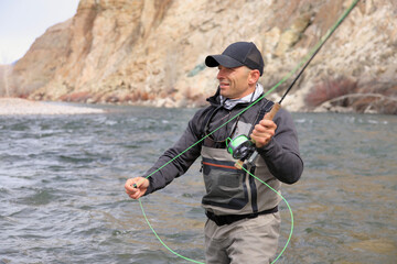 Fly fisherman casting for steelhead trout on the Salmon River in Idaho