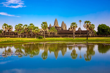 Fototapeta na wymiar Beautiful landscape of the ancient city of Angkor Wat in Cambodia. Towers of the temple of the Kmer people with reflection in the lake. The concept of travel to the sights of ancient civilizations.