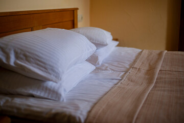 bed in hotel room, pillows in the hotel, fresh clean linen on the bed, a hotel room ready for...