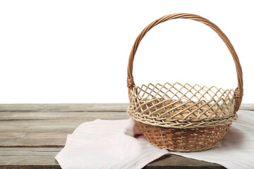 Obraz premium Empty wicker basket and cloth on wooden table against white background, space for text. Easter holiday