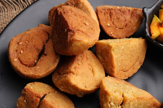 bafle or bati is popular main course dish in India served with dal daal brinjal curry jaggery gud and clarified butter or ghee