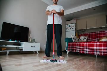 Man washing the floor. Doing chores concept. Mopping the floor. 