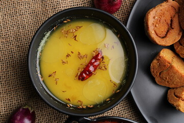 bafle or bati is popular main course dish in India served with dal daal brinjal curry jaggery gud and clarified butter or ghee