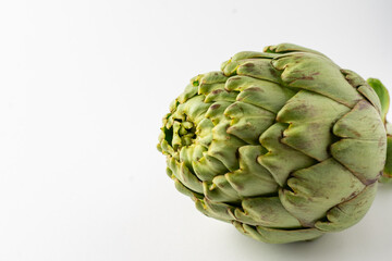Fototapeta premium Close-up of whole artichoke, on white background, horizontal, with copy space
