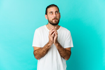 Young man with long hair look making up plan in mind, setting up an idea.