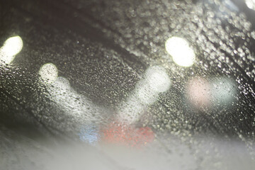 Blurred background with raindrops and lights.