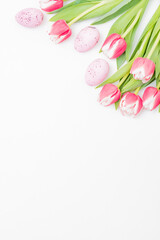 Fototapeta na wymiar Flat lay easter composition with pink tulips and eggs on white background