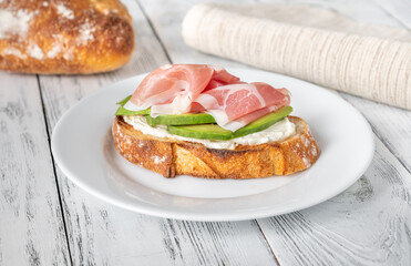 Toast with avocado, prosciutto and cream cheese