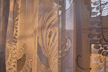white tulle curtain with a pattern on on the window, On the Sunset