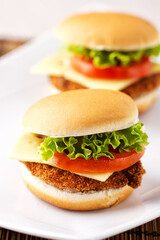 Mini Crispy Chicken Burger with Lettuce Tomato and Cheese.