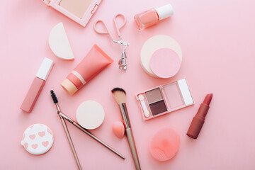 Female accessories for make up on pink background. Beauty concept.