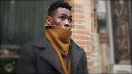 African man leaves home in the morning during winter season, elegant person steps out