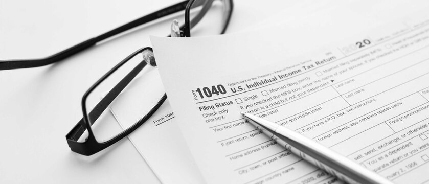 United States American IRS Internal Revenue Service income tax filing form 1040 for revenue reporting preparation with financial papers