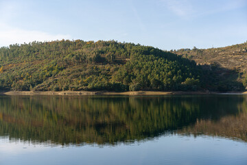 Fototapeta premium Apartadura dam nature landscape with reflection on the still water in Sao Mamede, Alentejo, Portugal