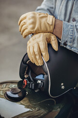 Close up set of an experienced driver. Close up motorcycle detail. Black helmet and yellow gloves of a motorcycle driver. Hipster lifestyle
