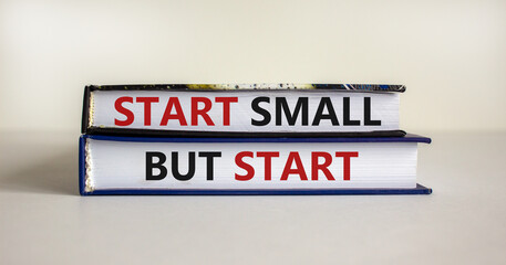 Start small but start symbol. Concept words 'Start small but start' on books on a beautiful white background. Business, motivational concept.