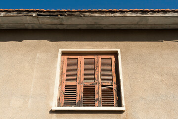 Shuttered window in house wall