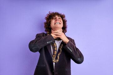 man suffocates for lack of air because the snake suffocates him, dangerous exotic animal is not intended for being with humans