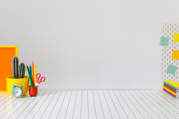 Creative young student desk mock up with multicolour school supplies. 