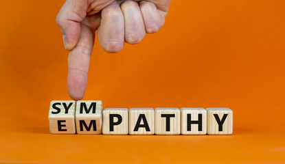 From empathy to sympathy. Businessman turns cubes and changes the word 'empathy' to 'sympathy'....