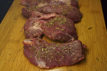 beef tenderloin steak seasoned on wooden board