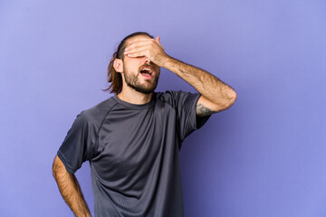 Young man with long hair look shrugs shoulders and open eyes confused.