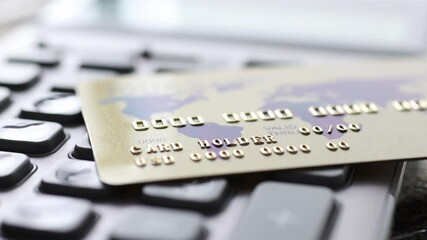 Credit bank card lying on calculator 4k movie. Payment of taxes concept