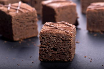 Chocolate brownie cake cubes on a dark background
