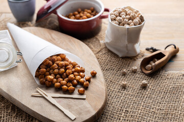 Vegan grilled chickpeas. Homemade vegan chickpeas, Crispy roasted organic chickpeas . Served as a snack in a bowl, on a white background.